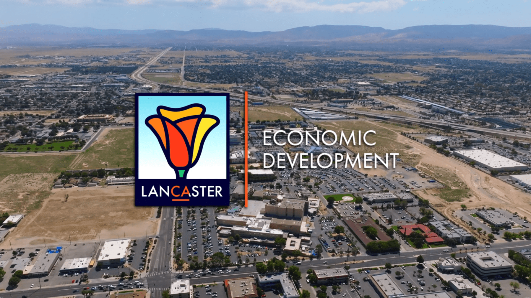 Aerial view of Lancaster, California, featuring the Economic Development text and a rose logo in the foreground, highlighting burgeoning retail opportunities.