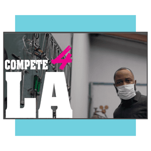 A man wearing a mask stands beside technical equipment. Bold text reads COMPETE 4 LA with a blue background accent.