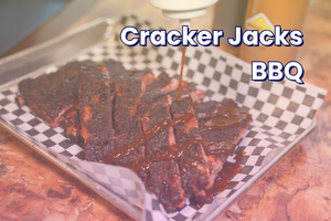 Close-up of glazed Cracker Jacks BBQ ribs on a tray.