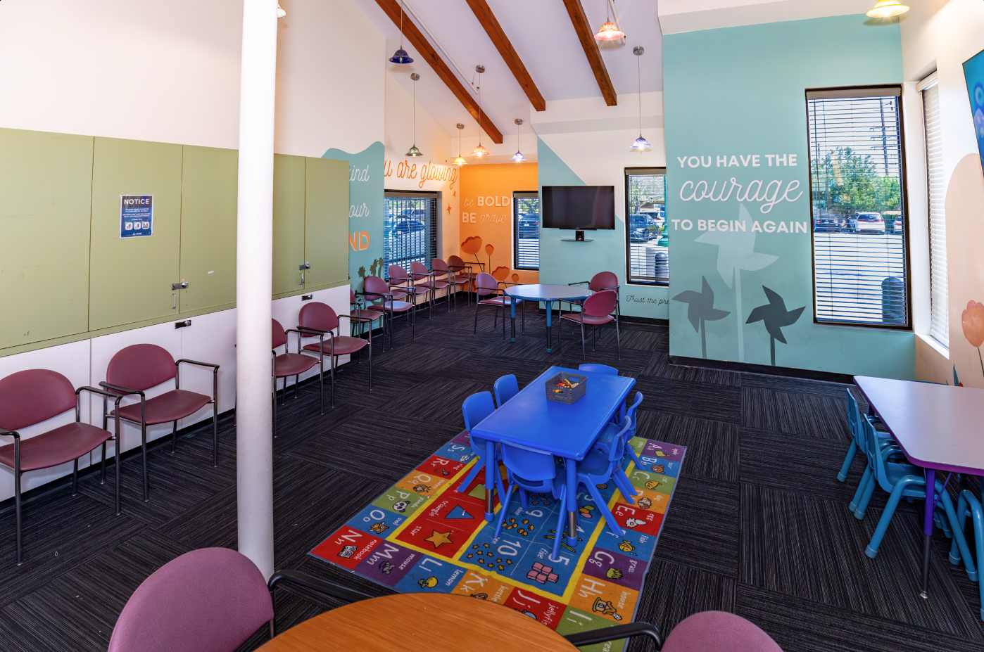 Bright children's playroom with colorful decor and educational posters.